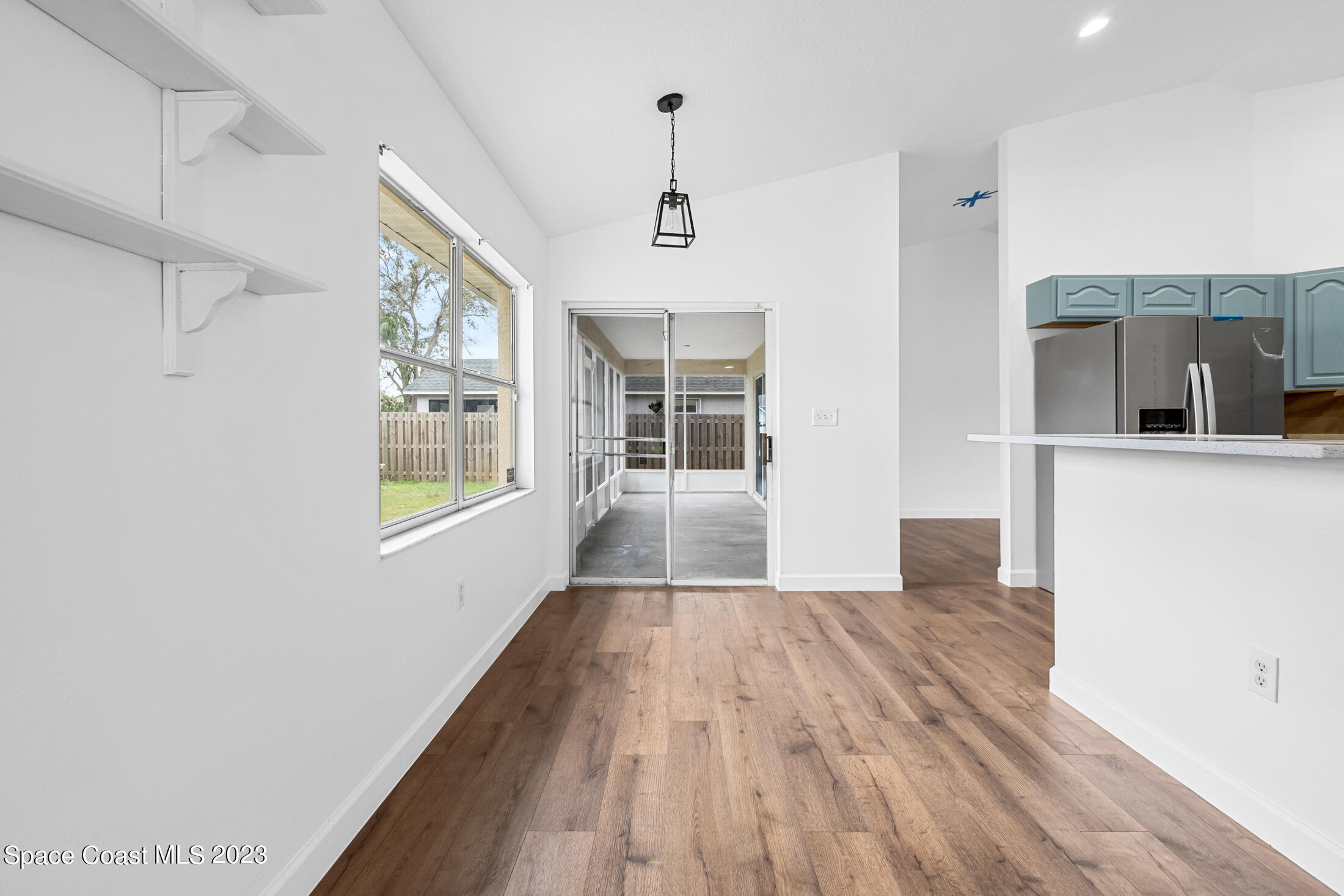 1940 Slone Boulevard Melbourne, FL 32935 - Photo 12 of 27 a view of a hallway with wooden floor and a living room