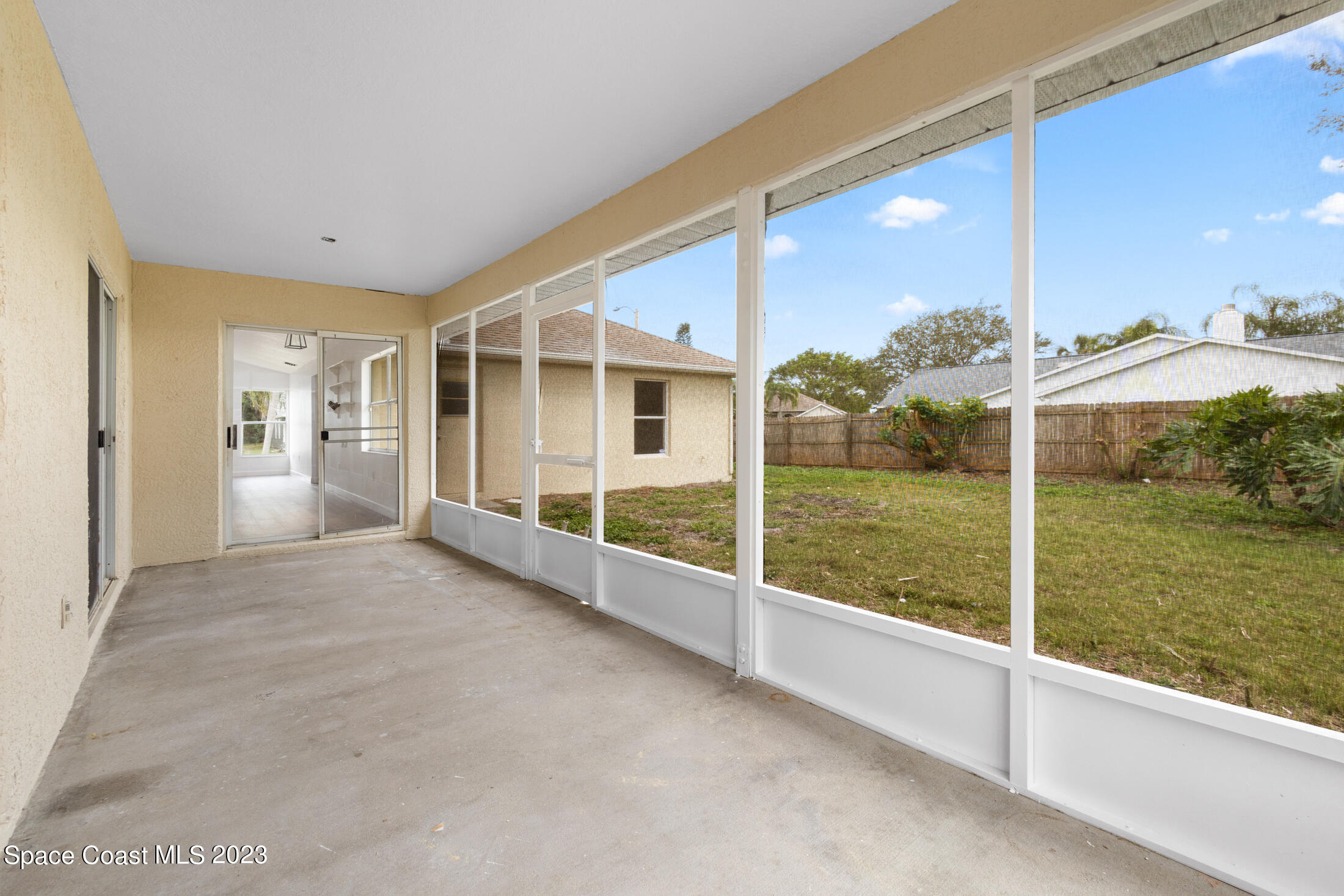 1940 Slone Boulevard Melbourne, FL 32935 - Photo 13 of 27 a view of an empty room with a floor to ceiling window and a yard