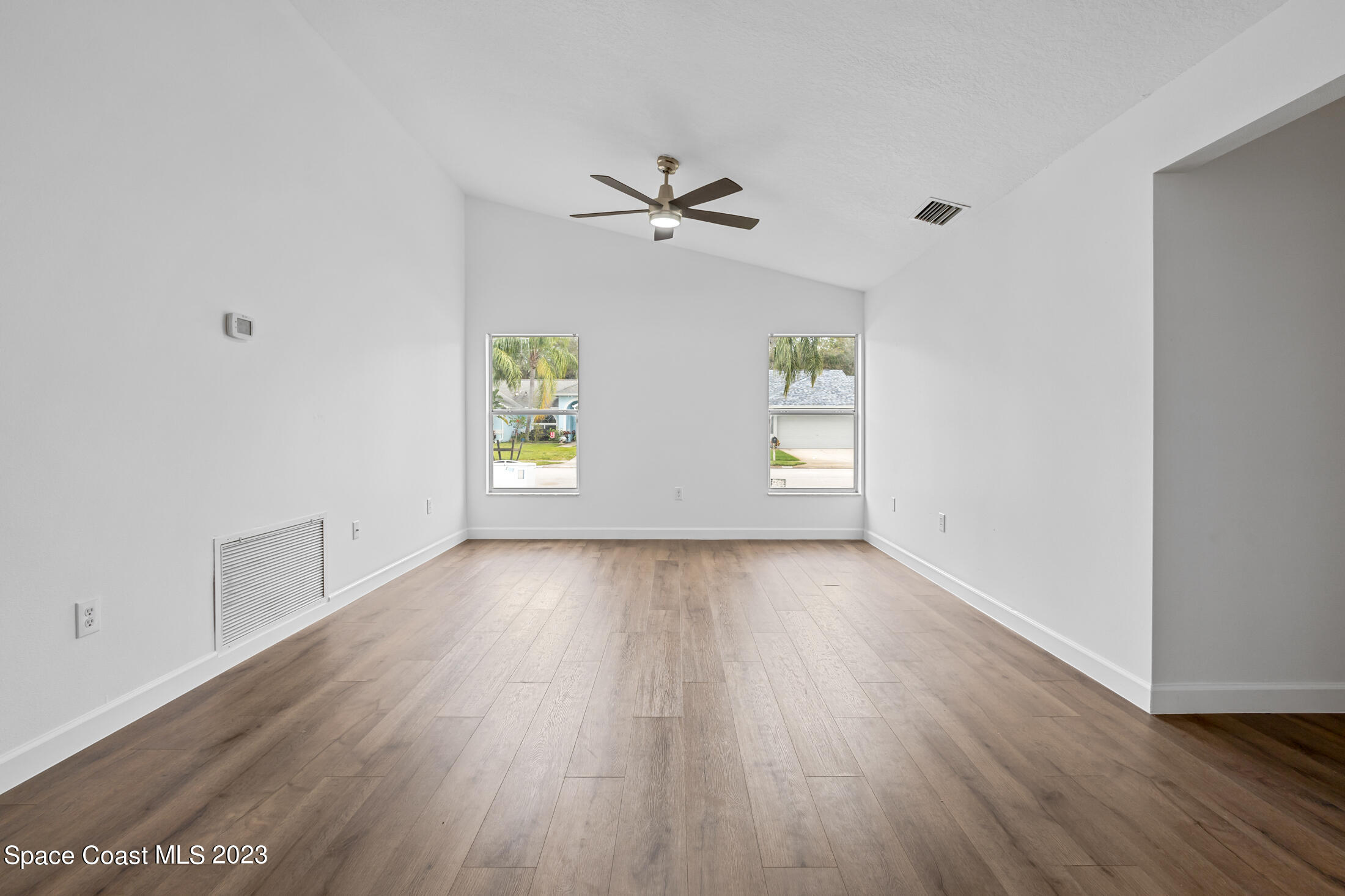 1940 Slone Boulevard Melbourne, FL 32935 - Photo 14 of 27 an empty room with windows and ceiling fan