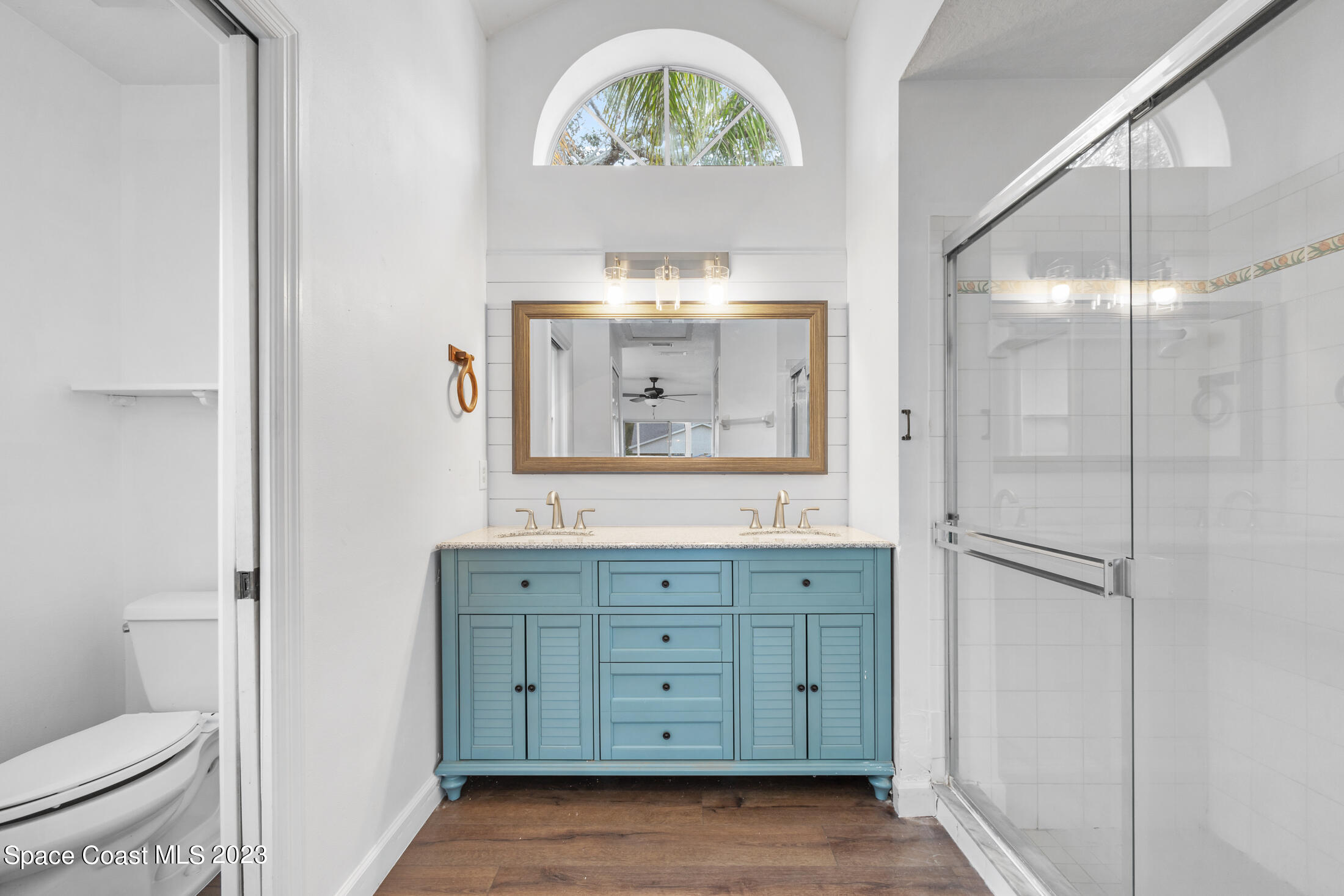 1940 Slone Boulevard Melbourne, FL 32935 - Photo 16 of 27 a bathroom with a sink a toilet and a mirror