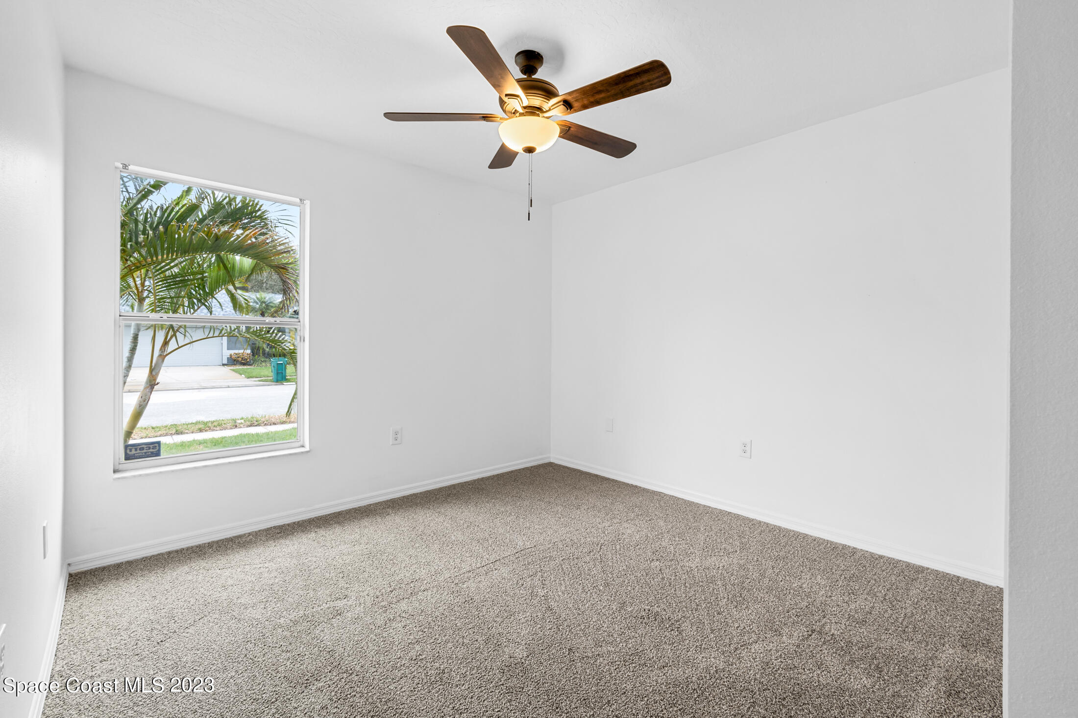 1940 Slone Boulevard Melbourne, FL 32935 - Photo 20 of 27 an empty room with a window and a fan