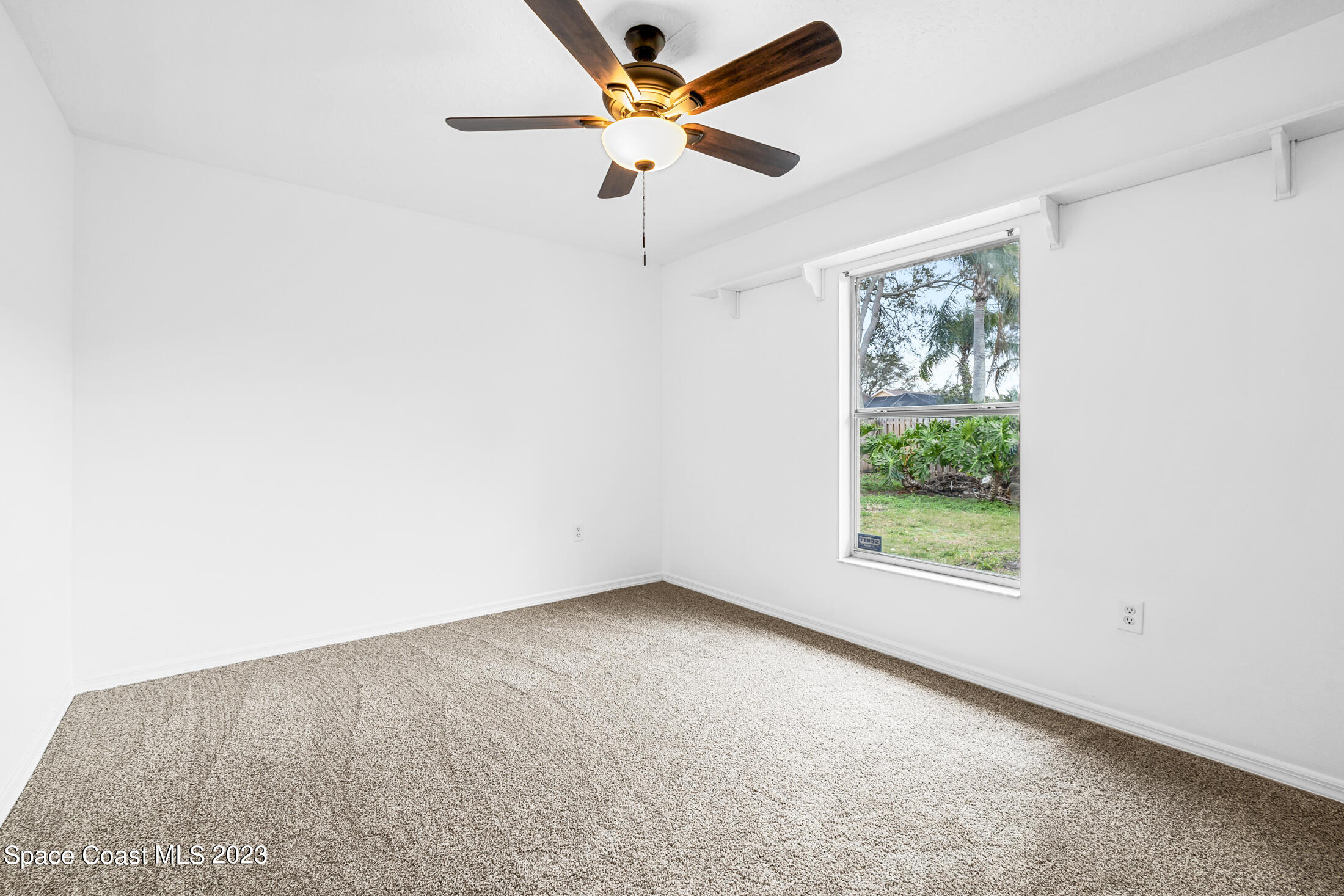 1940 Slone Boulevard Melbourne, FL 32935 - Photo 21 of 27 an empty room with a window and a fan