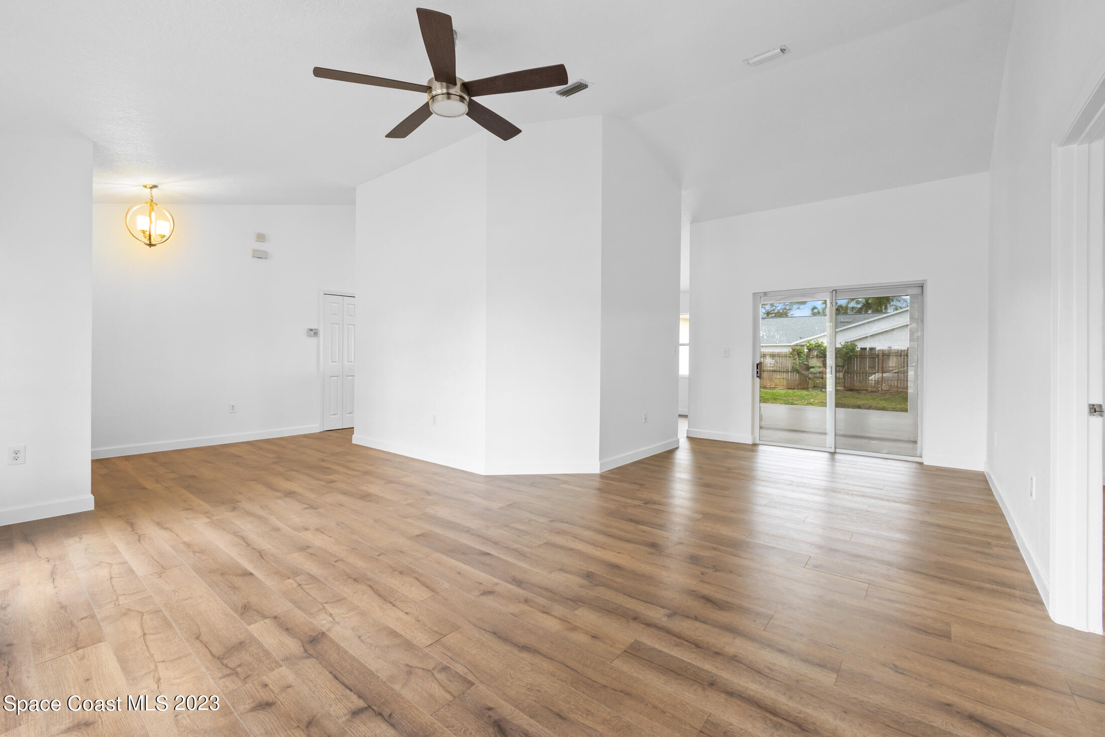 1940 Slone Boulevard Melbourne, FL 32935 - Photo 7 of 27 a view of empty room with wooden floor and fan