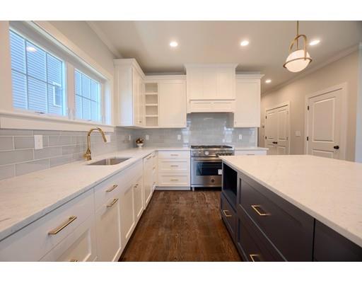 a kitchen with white cabinets appliances and a sink