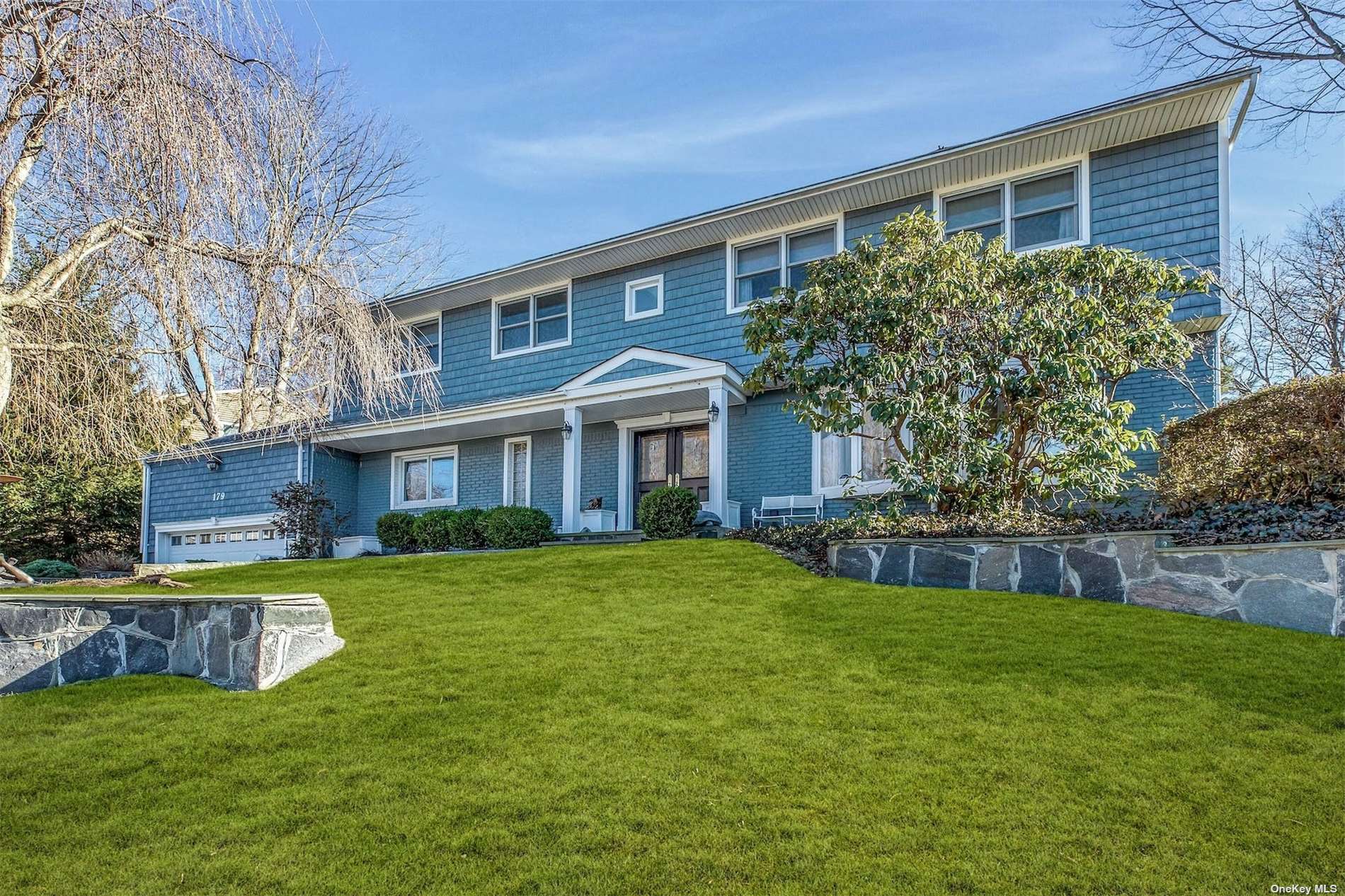 179 Chestnut Road Manhasset, NY 11030 - Photo 1 of 1 a view of a house with a yard