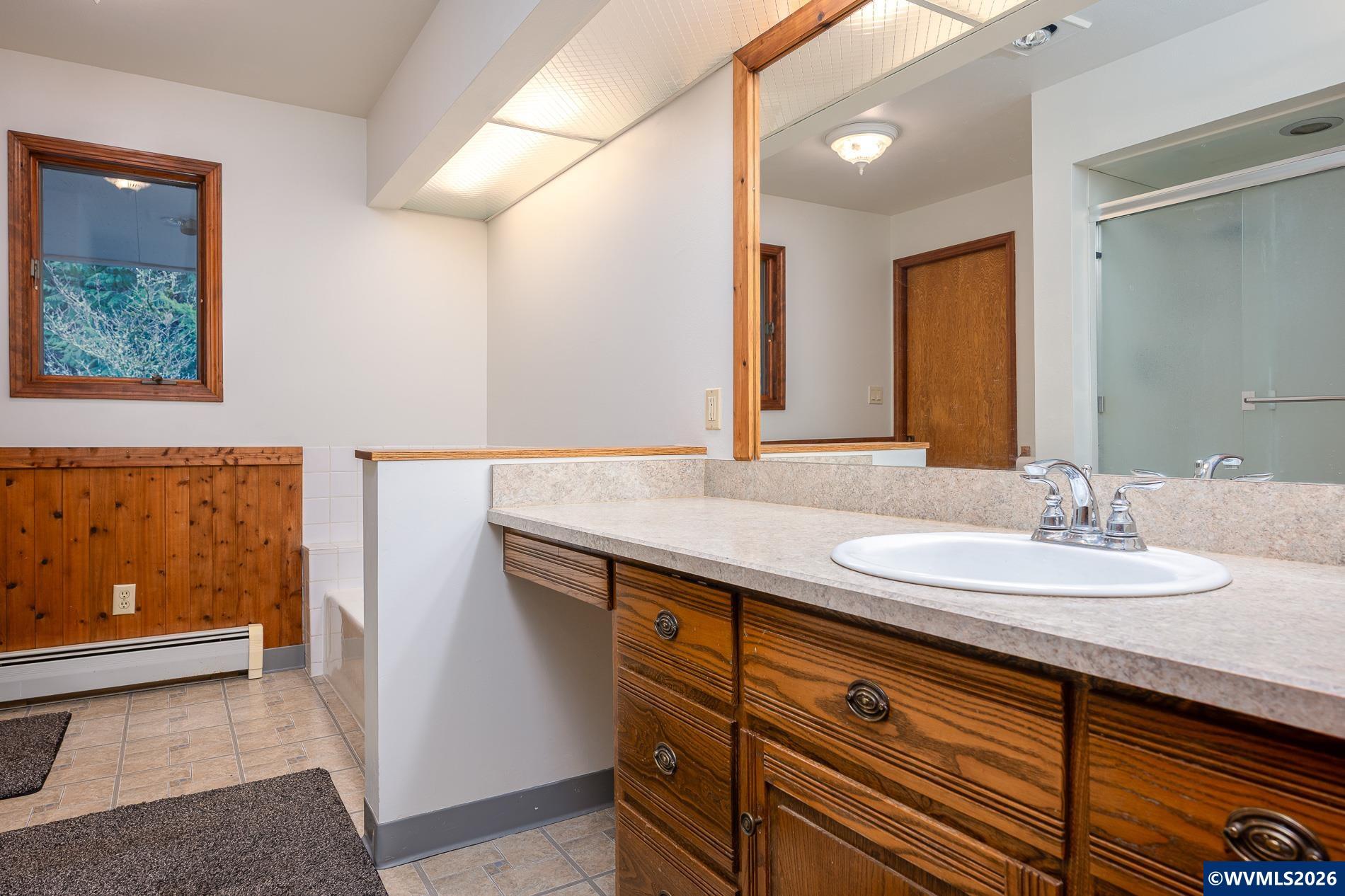 27572 South Kinzy Road Estacada, OR 97023 - Photo 23 of 50 a bathroom with a granite countertop sink and a mirror