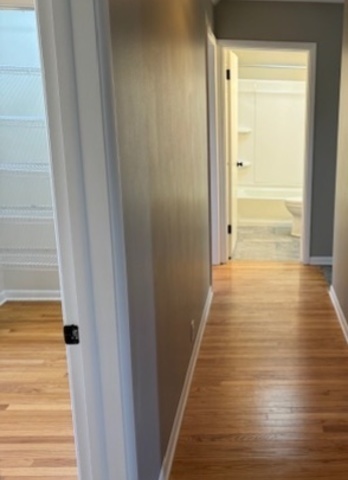 774 Considine Road Geneva, IL 60134 - Photo 14 of 43 a view of a hallway with wooden floor and staircase