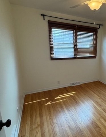 774 Considine Road Geneva, IL 60134 - Photo 15 of 43 a view of a room with wooden floor and windows