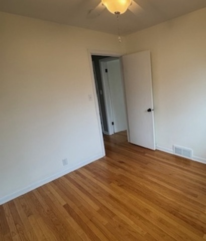 774 Considine Road Geneva, IL 60134 - Photo 17 of 43 a view of empty room with wooden floor and fan