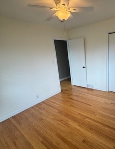 774 Considine Road Geneva, IL 60134 - Photo 19 of 43 an empty room with wooden floor and fan