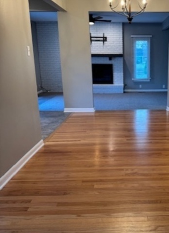 774 Considine Road Geneva, IL 60134 - Photo 26 of 43 a view of empty room with wooden floor and fireplace