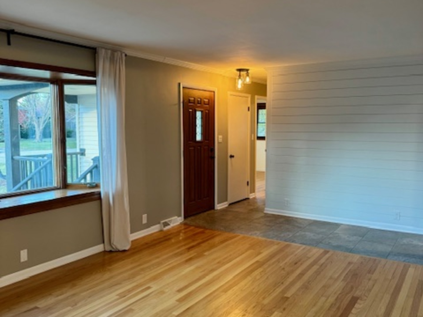 774 Considine Road Geneva, IL 60134 - Photo 3 of 43 an empty room with wooden floor and windows
