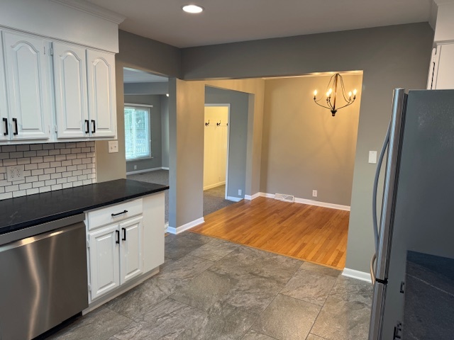 774 Considine Road Geneva, IL 60134 - Photo 7 of 43 a kitchen with white cabinets and refrigerator