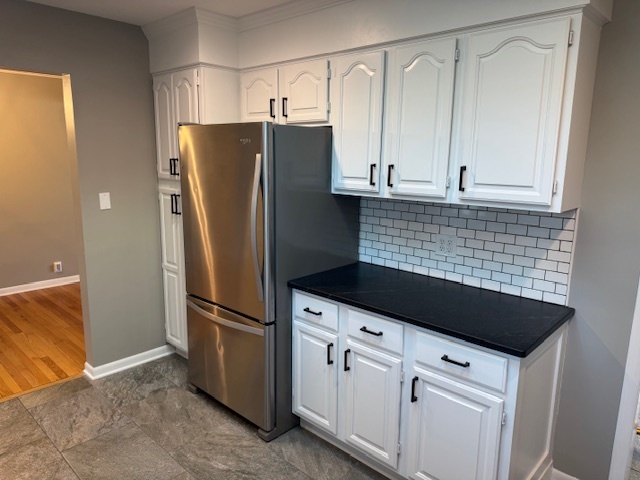 774 Considine Road Geneva, IL 60134 - Photo 8 of 43 a kitchen with granite countertop white cabinets and stainless steel appliances