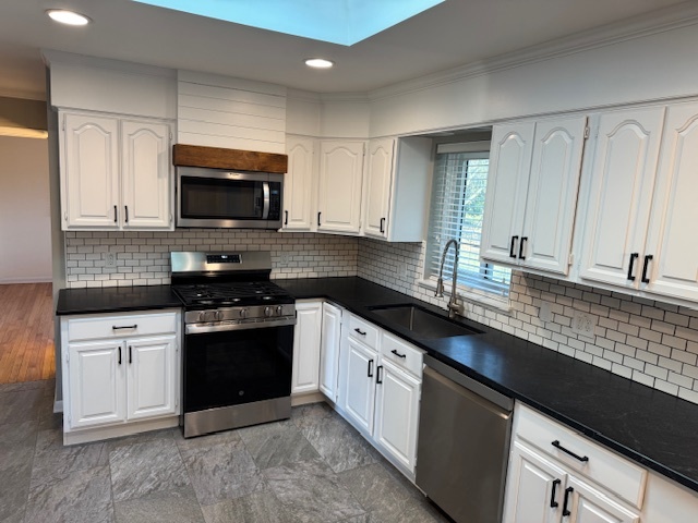 774 Considine Road Geneva, IL 60134 - Photo 9 of 43 a kitchen with stainless steel appliances granite countertop a stove a sink and a microwave