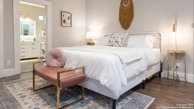 a bedroom with a bed and a mirror