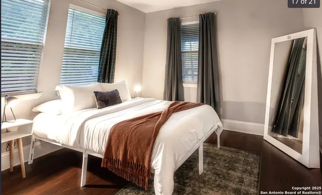 a bedroom with a bed and a large mirror