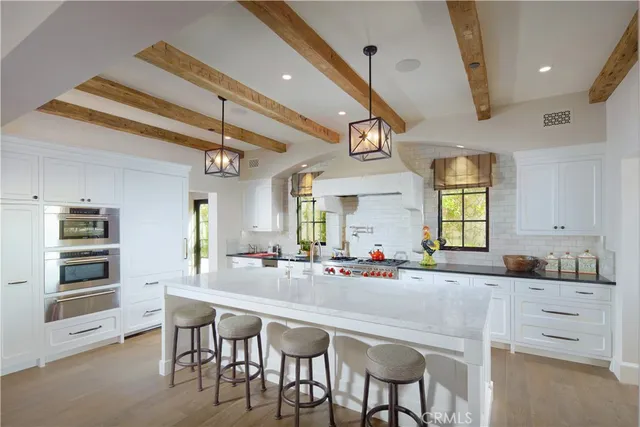 a kitchen with stainless steel appliances kitchen island granite countertop a table and chairs