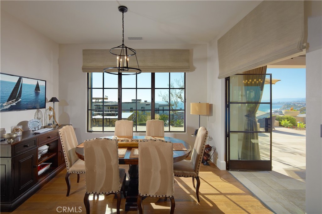 17 Pacific Ridge Place Dana Point, CA 92629 - Photo 13 of 46 a dining room with furniture a chandelier and wooden floor