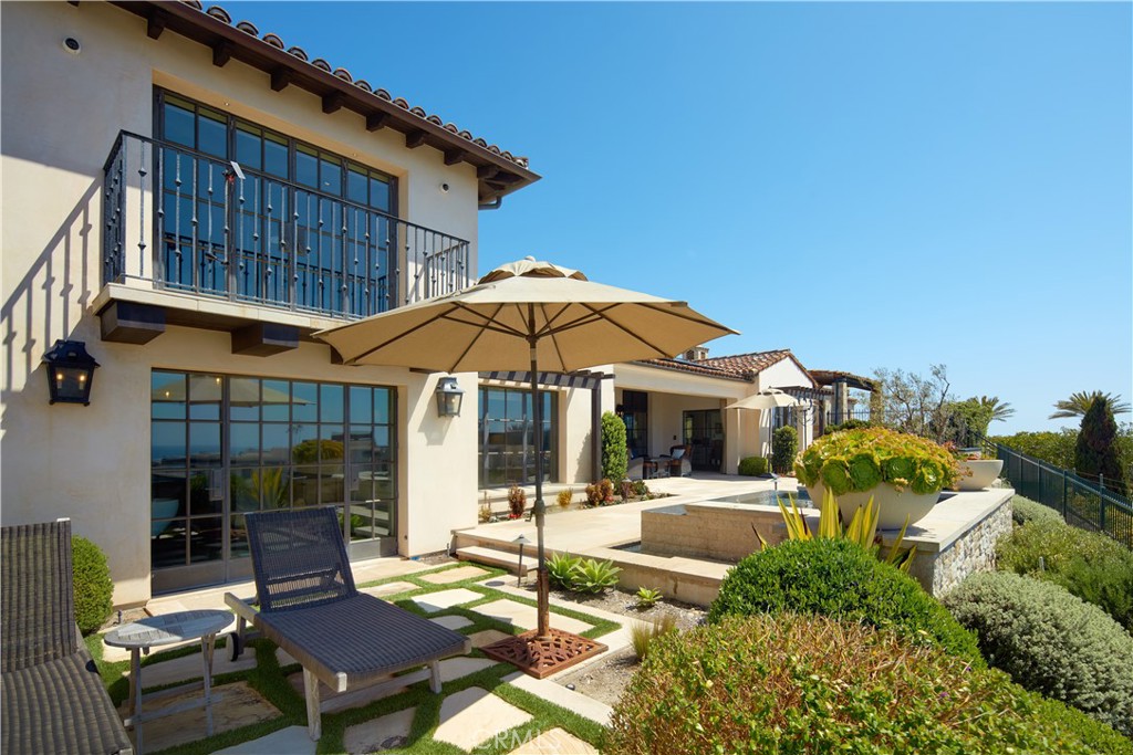 17 Pacific Ridge Place Dana Point, CA 92629 - Photo 19 of 46 a patio with a table and chairs under an umbrella