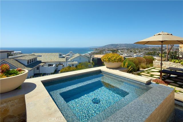an aerial view of a house with a swimming pool fire pit and outdoor seating