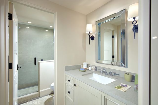 a bathroom with a granite countertop sink toilet and shower