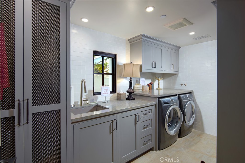 17 Pacific Ridge Place Dana Point, CA 92629 - Photo 39 of 46 a utility room with cabinets washer and dryer