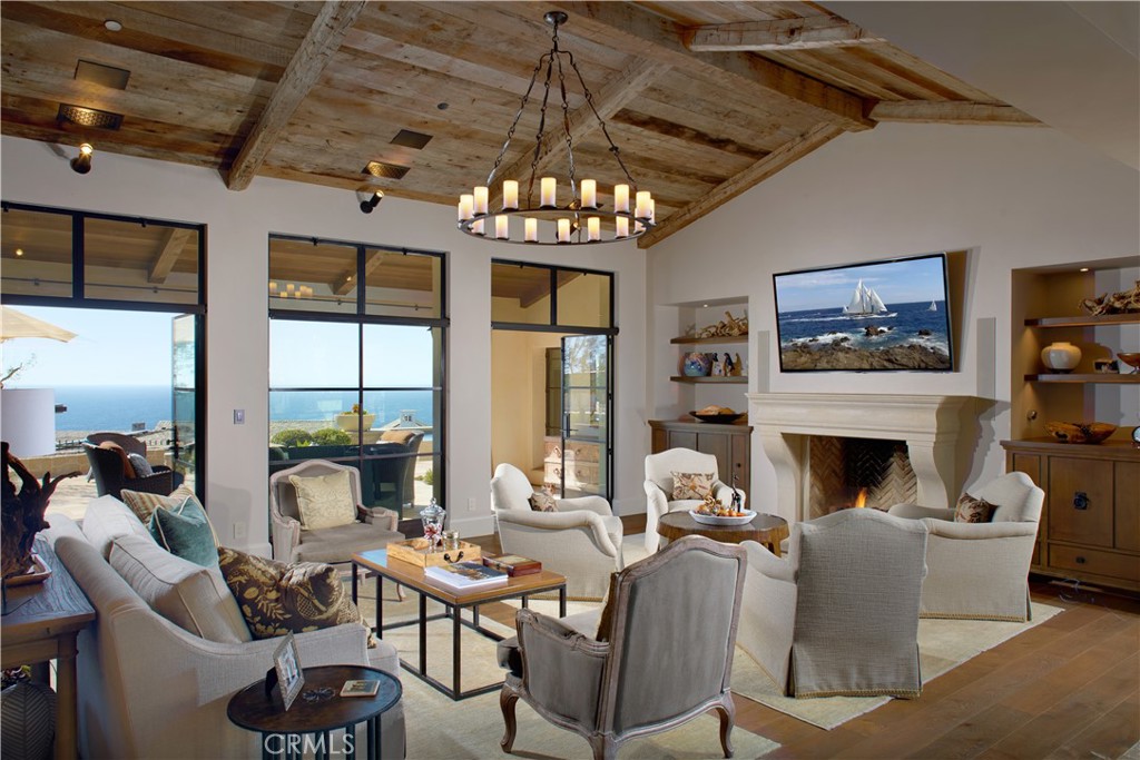 17 Pacific Ridge Place Dana Point, CA 92629 - Photo 10 of 46 a living room with furniture a fireplace and a chandelier