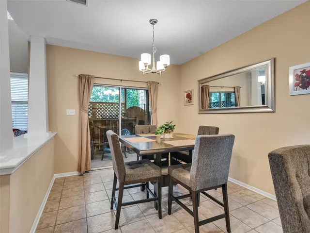 a kitchen with cabinets and chairs