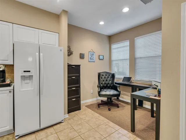 a view of a workspace with furniture and a window