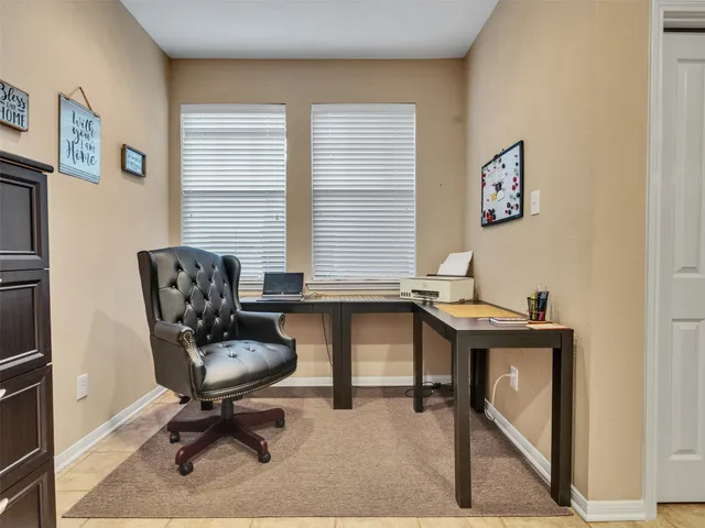 a bedroom with a bed and glass door