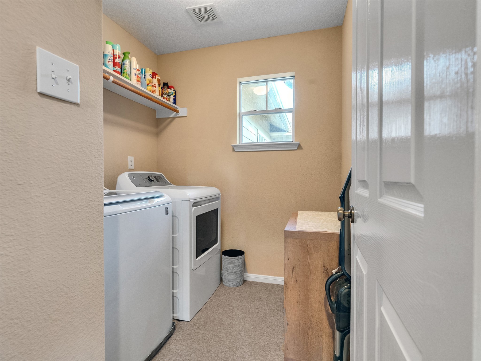 83 Scarlet Woods Court, Unit 83 The Woodlands, TX 77380 - Photo 25 of 34 Upstairs laundry room with full-size washer and dryer. The ironing board is just out of view.