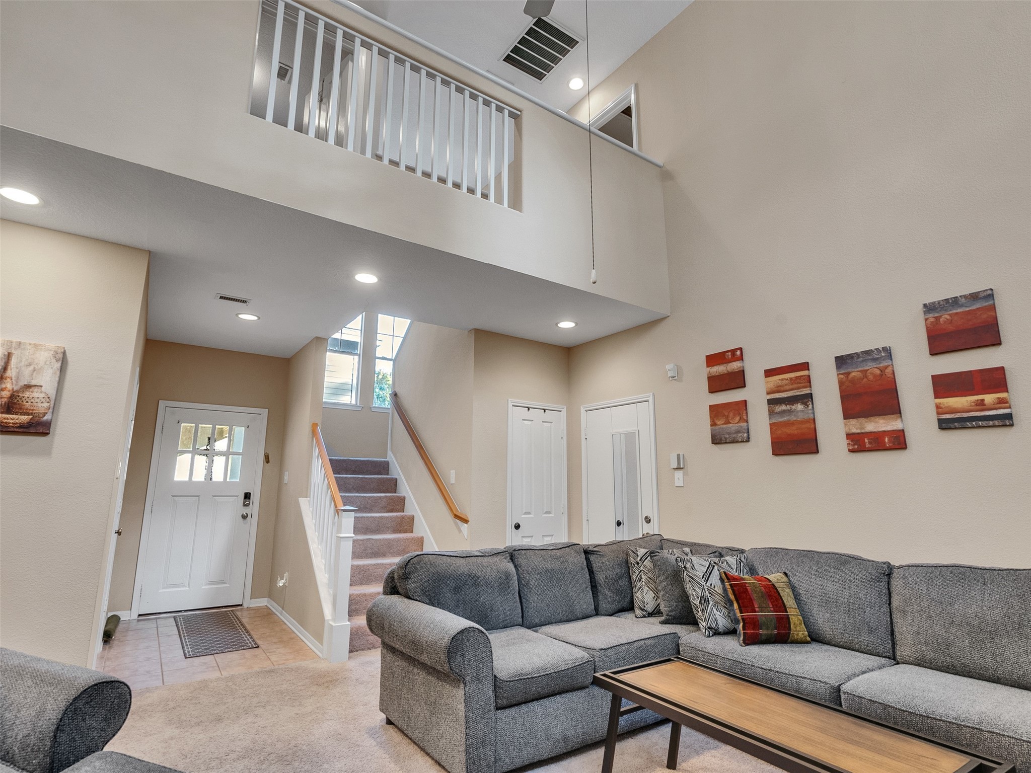 83 Scarlet Woods Court, Unit 83 The Woodlands, TX 77380 - Photo 6 of 34 Entry door from the garage is to the right of the stairs. More windows greet you at every angle including the middle landing!