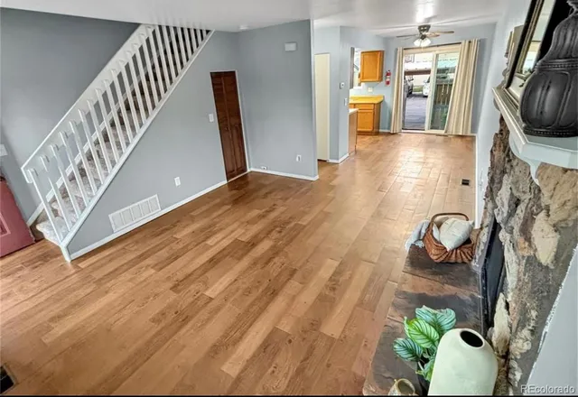 a view of an entryway with wooden floor and a flat screen tv