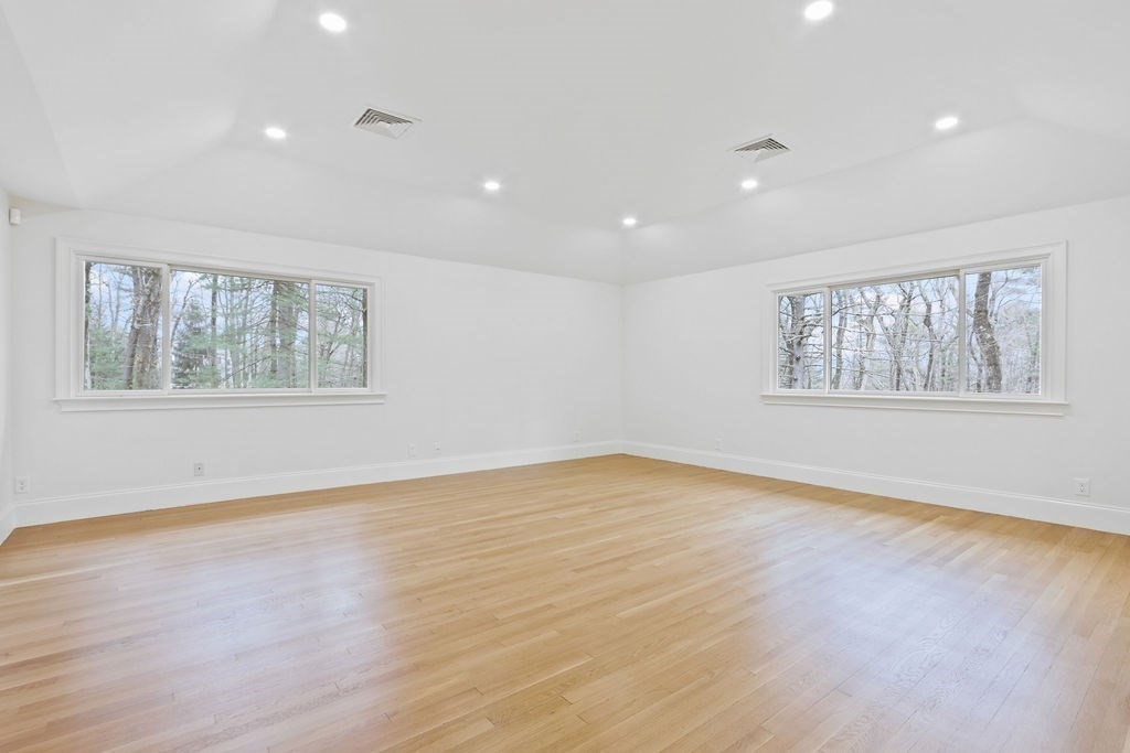 80 Doublet Hill Road Weston, MA 02493 - Photo 21 of 38 a view of an empty room with wooden floor and a window