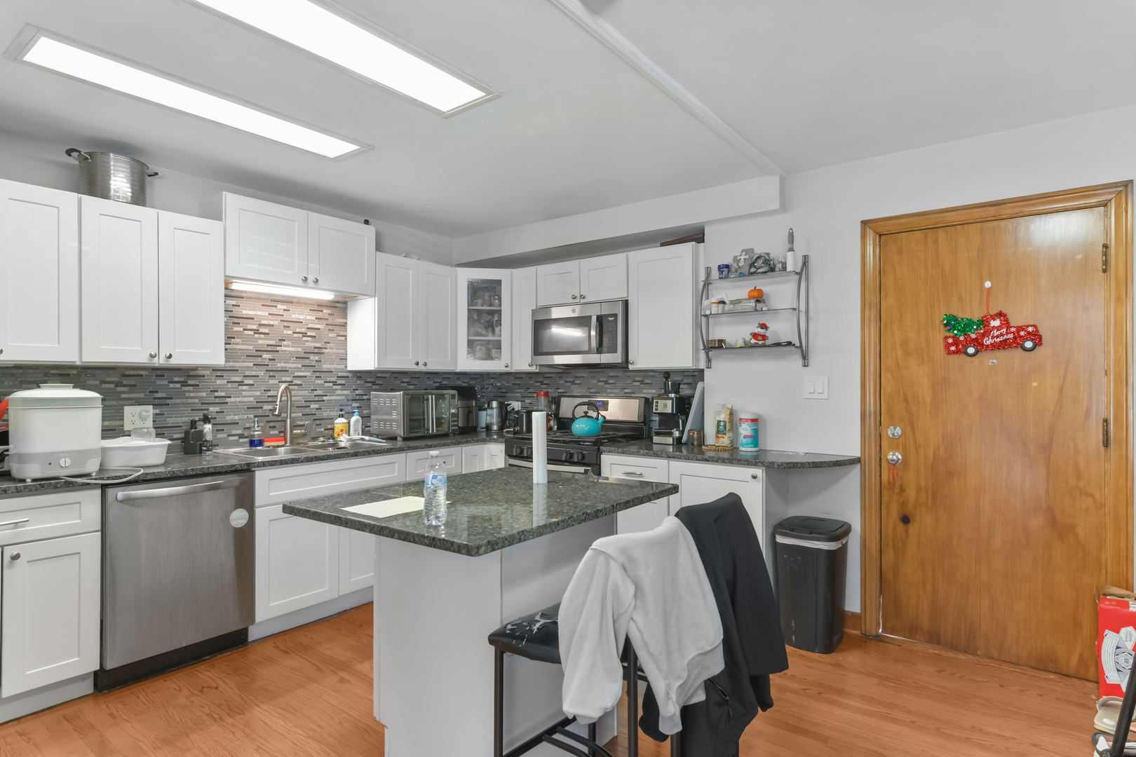 7124 West Higgins Avenue Chicago, IL 60656 - Photo 26 of 33 a kitchen with granite countertop a sink stove and refrigerator