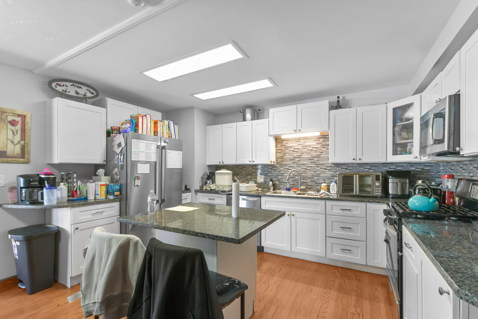 7124 West Higgins Avenue Chicago, IL 60656 - Photo 27 of 33 a kitchen with granite countertop a sink stove and cabinets