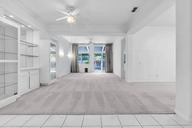 a view of empty room with closet and fan