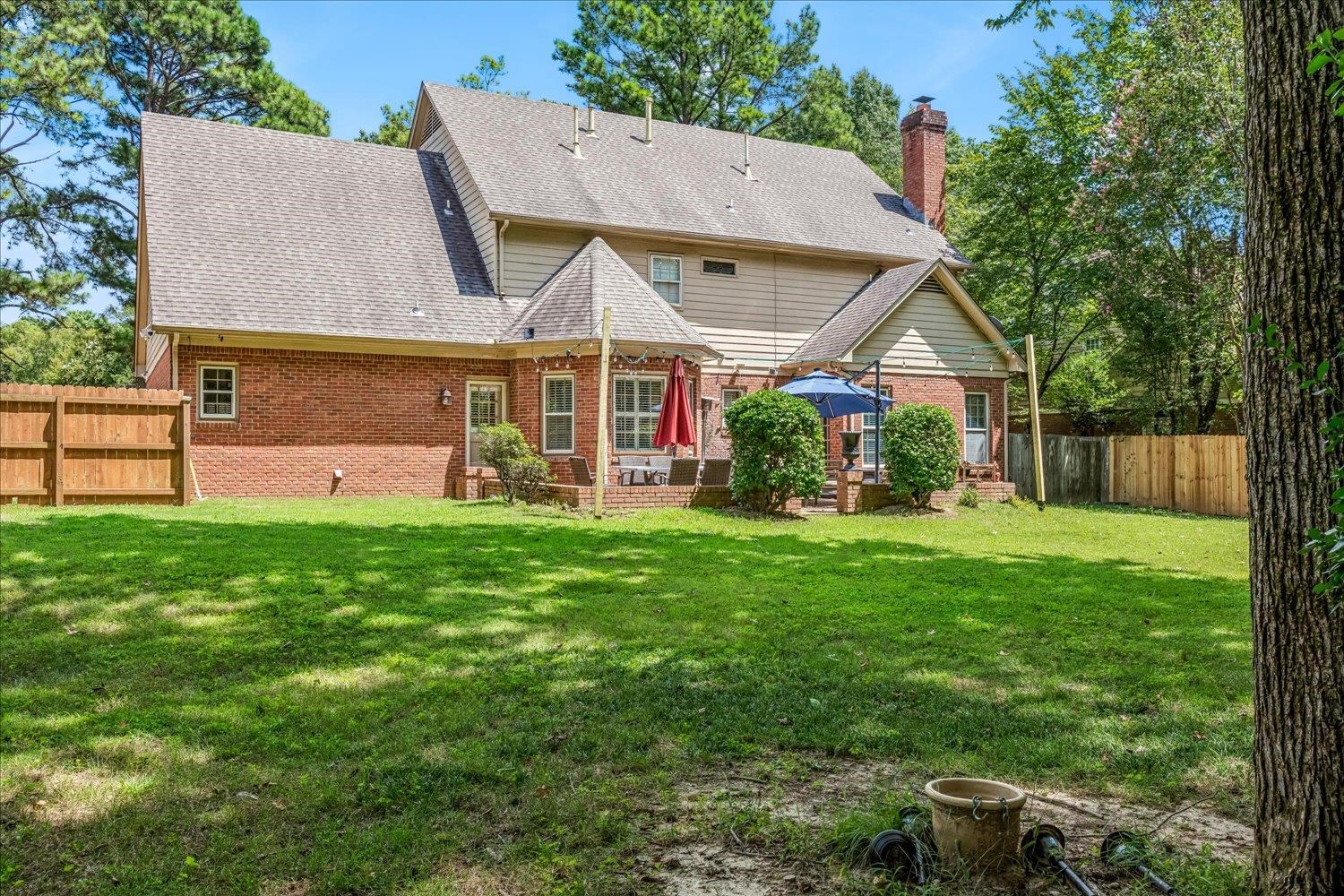 65 Summer Grove Road Memphis, TN 38018 - Photo 35 of 38 Expansive green lawn with mature trees and wood fencing