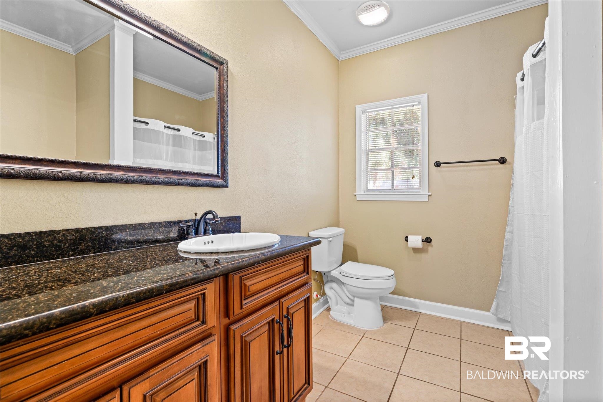 1310 Brown Street Mobile, AL 36604 - Photo 12 of 18 Bathroom featuring a shower with shower curtain, toilet, tile patterned floors, vanity, and ornamental molding