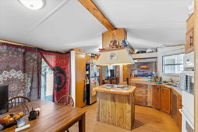 a kitchen with stainless steel appliances kitchen island granite countertop a sink and cabinets