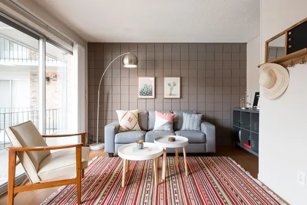 a living room with furniture and a wooden floor