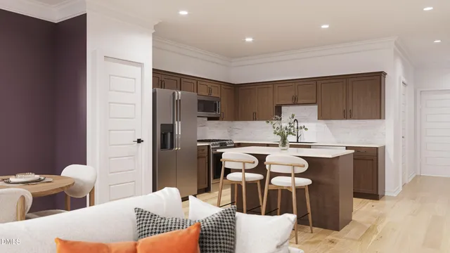 a kitchen with stainless steel appliances granite countertop a kitchen island a stove a cabinets a sink and a refrigerator