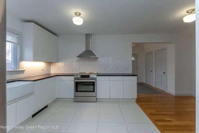 a kitchen with stainless steel appliances granite countertop a refrigerator sink and cabinets