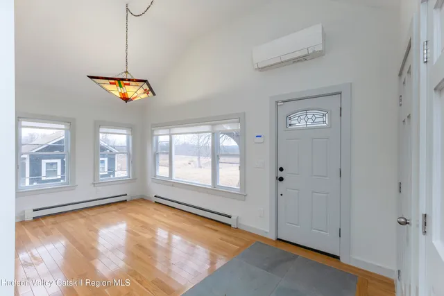 a view of a room with wooden floor and a sink