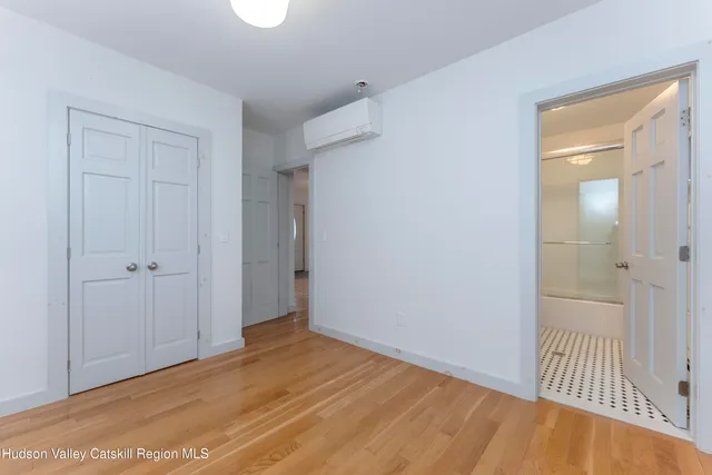 a bathroom with a shower a mirror a toilet and a sink