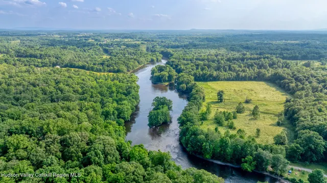 an aerial view of a houses with a yard