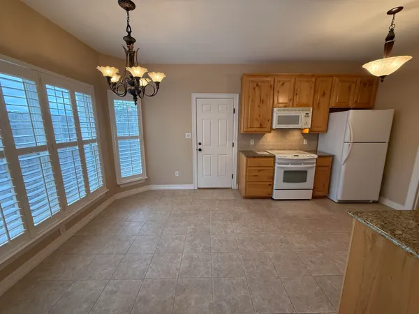 a view of a kitchen with a stove cabinets and a ceiling fan