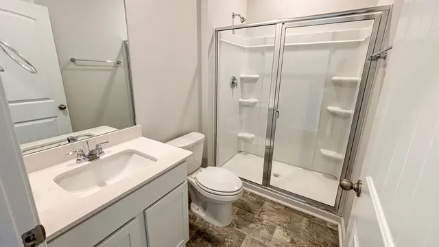 a bathroom with a sink toilet and shower