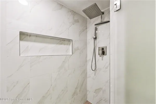 a bathroom with a glass shower door